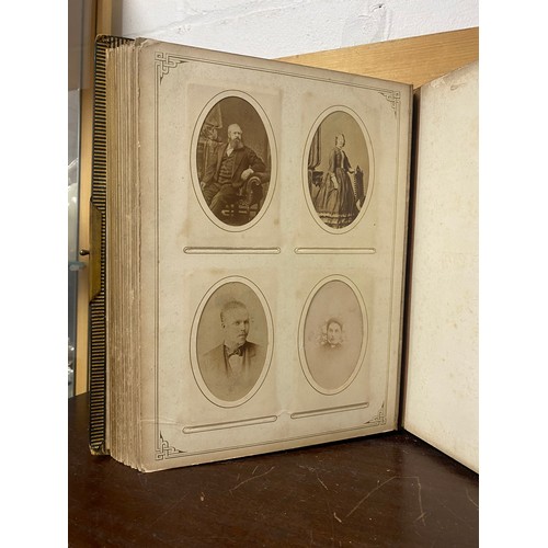 142 - A Victorian photograph album, containing approximately 100 carte de visites -