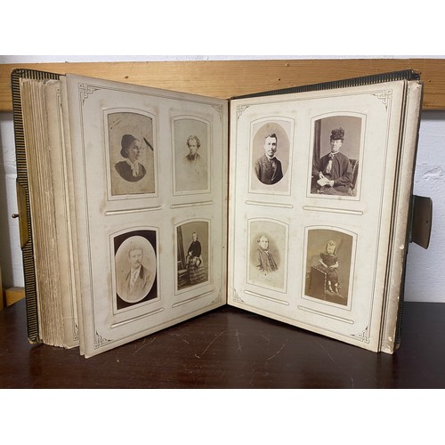 142 - A Victorian photograph album, containing approximately 100 carte de visites -