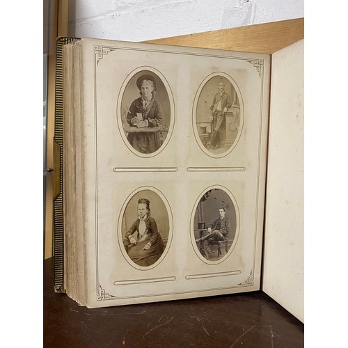 142 - A Victorian photograph album, containing approximately 100 carte de visites -