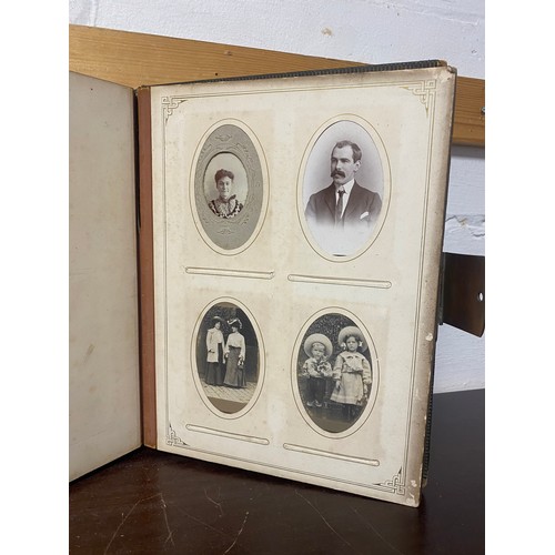 142 - A Victorian photograph album, containing approximately 100 carte de visites -