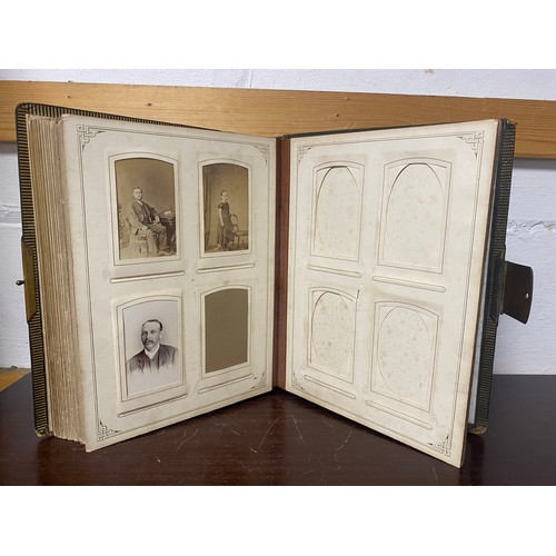 142 - A Victorian photograph album, containing approximately 100 carte de visites -