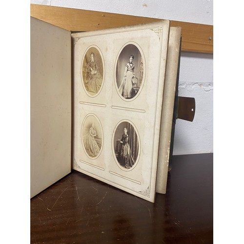 142 - A Victorian photograph album, containing approximately 100 carte de visites -