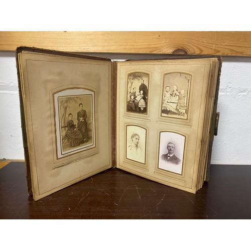 143 - A Victorian photograph album, containing approximately 68 carte de visites and photographs, and some... 