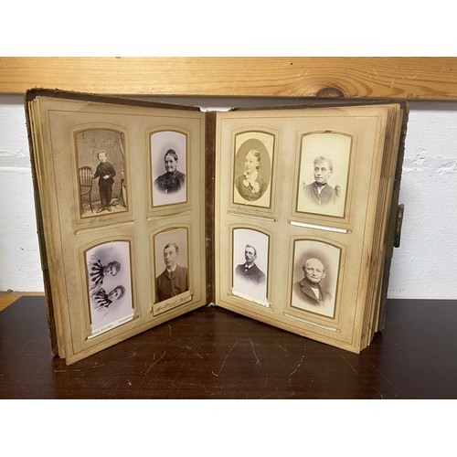 143 - A Victorian photograph album, containing approximately 68 carte de visites and photographs, and some... 