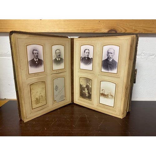 143 - A Victorian photograph album, containing approximately 68 carte de visites and photographs, and some... 