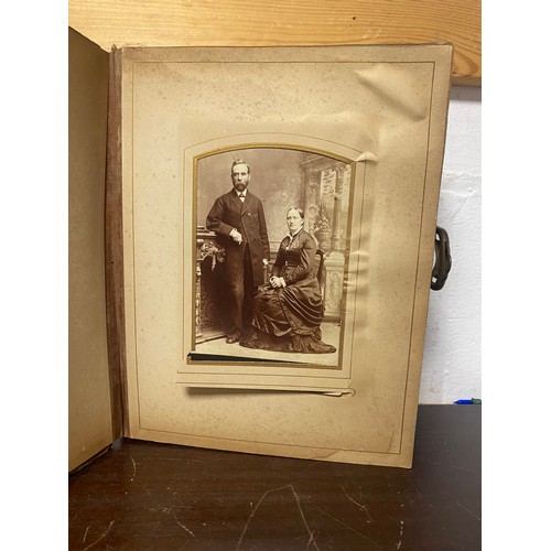 143 - A Victorian photograph album, containing approximately 68 carte de visites and photographs, and some... 