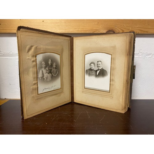 143 - A Victorian photograph album, containing approximately 68 carte de visites and photographs, and some... 
