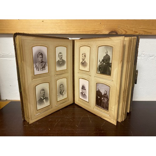 143 - A Victorian photograph album, containing approximately 68 carte de visites and photographs, and some... 