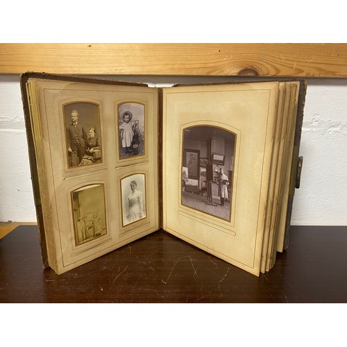 143 - A Victorian photograph album, containing approximately 68 carte de visites and photographs, and some... 
