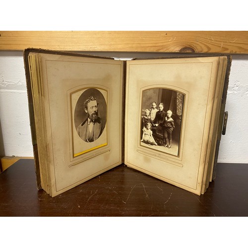 143 - A Victorian photograph album, containing approximately 68 carte de visites and photographs, and some... 