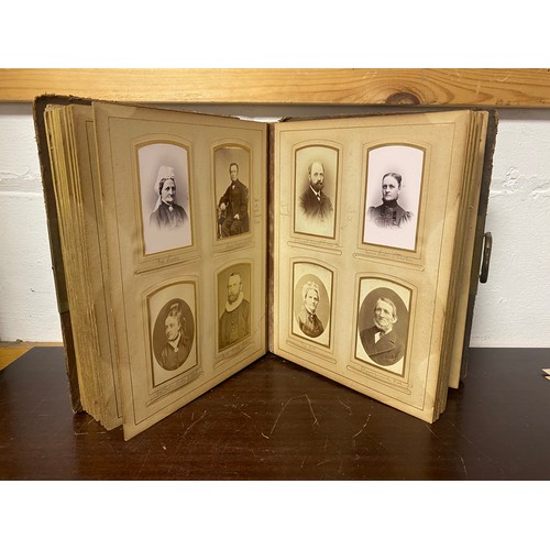 143 - A Victorian photograph album, containing approximately 68 carte de visites and photographs, and some... 