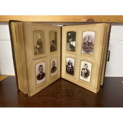 143 - A Victorian photograph album, containing approximately 68 carte de visites and photographs, and some... 