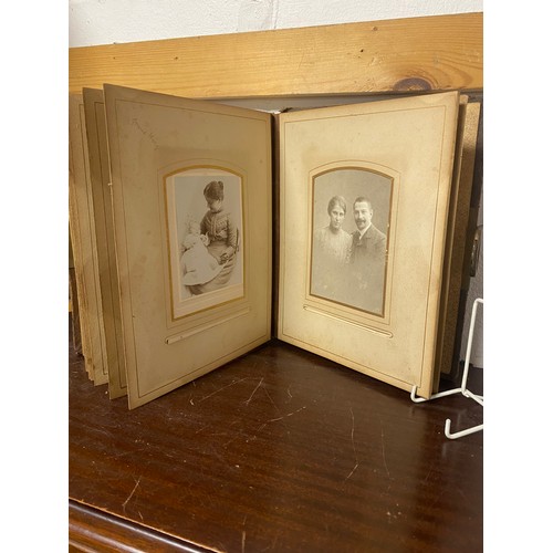 143 - A Victorian photograph album, containing approximately 68 carte de visites and photographs, and some... 
