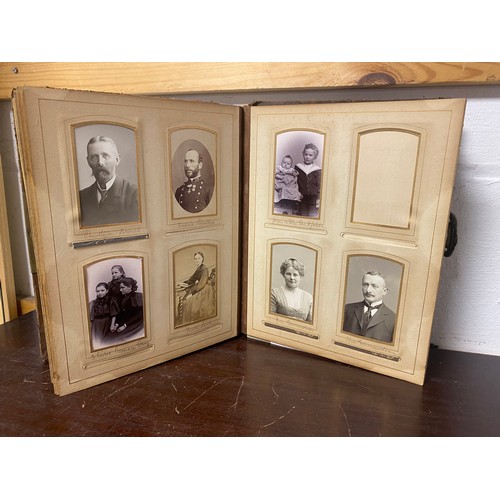 143 - A Victorian photograph album, containing approximately 68 carte de visites and photographs, and some... 