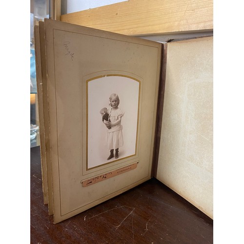 143 - A Victorian photograph album, containing approximately 68 carte de visites and photographs, and some... 