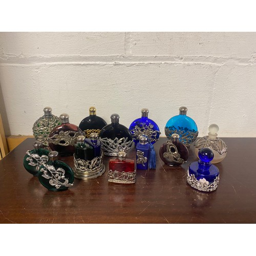 159 - A collection of coloured glass scent bottles, including examples by First Impressions -