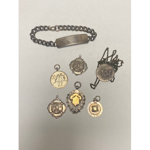 11 - A small quantity of silver medals, ID bracelet etc -