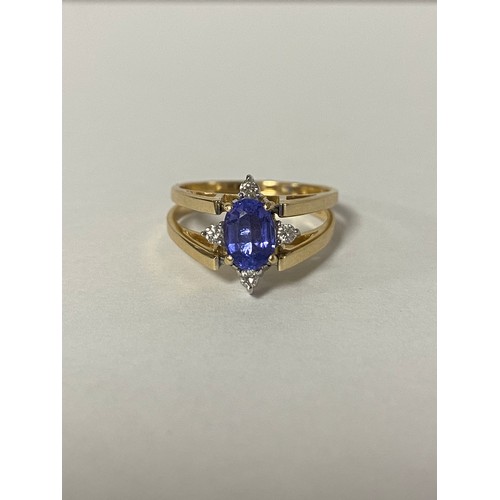17 - A tanzanite and diamond dress ring, of 'flip over' design, one side set with an oval tanzanite and d... 