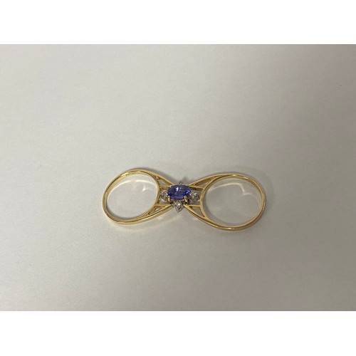 17 - A tanzanite and diamond dress ring, of 'flip over' design, one side set with an oval tanzanite and d... 