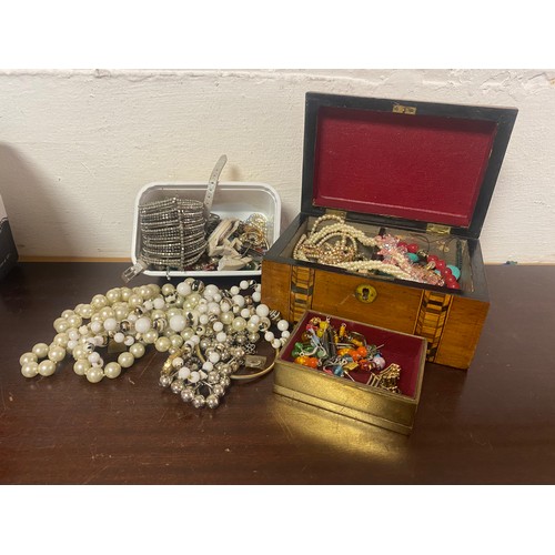 25 - A 19th century inlaid caddy containing a quantity of costume jewellery -