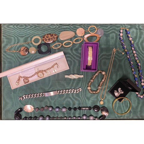 33 - A heavy silver ID bracelet, a silver locket and a quantity of costume jewellery -