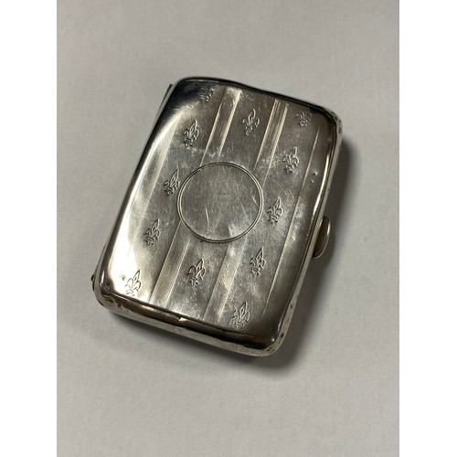 34 - An Edwardian silver cigarette case, Birmingham 1910, with fleur de lys decoration -