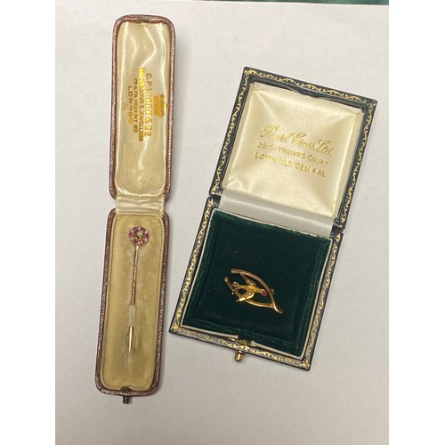 42 - An Edwardian ruby and seed pearl set stick pin, together with an Edwardian wishbone brooch set with ... 