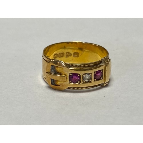 43 - A late Victorian 18ct gold ring, of buckle design, set with an old cut diamond and two rubies -