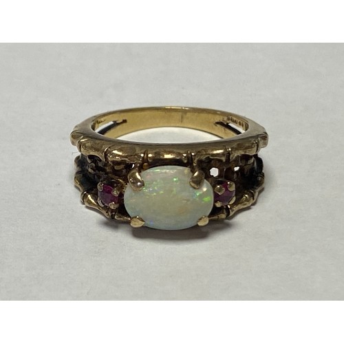 46 - A 9ct gold ring, set with a opal cabochon and two small rubies -