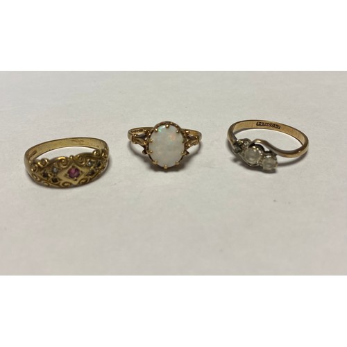 48 - A 9ct gold ring, set with an opal cabochon and two other 9ct rings (stones deficient) -
