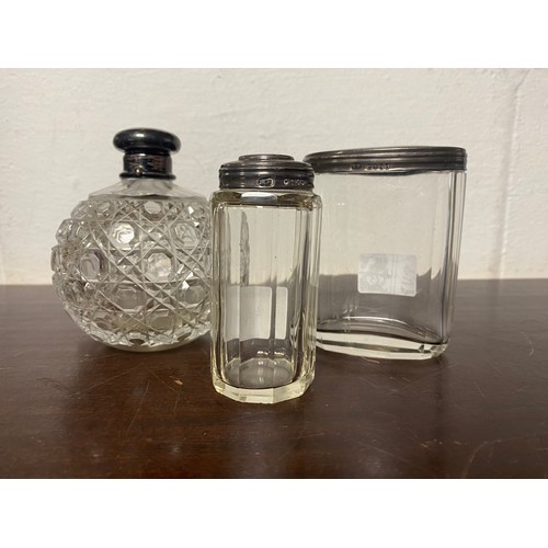 4 - A Victorian cut glass and silver scent bottle, Birmingham 1883, and two other silver mounted bottles... 