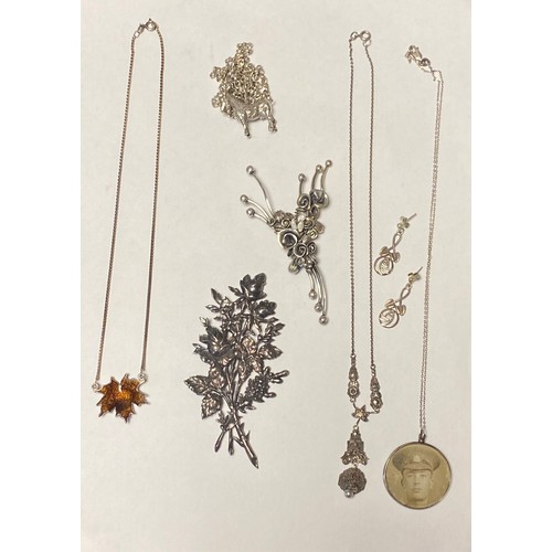 27 - A white metal brooch, of stylised spray design, set with freshwater pearls, together with another fl... 