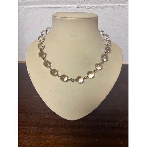 9 - An Art Deco Pools of Light bead necklace, composed of  crystal spheres wrapped with wire links, to w... 