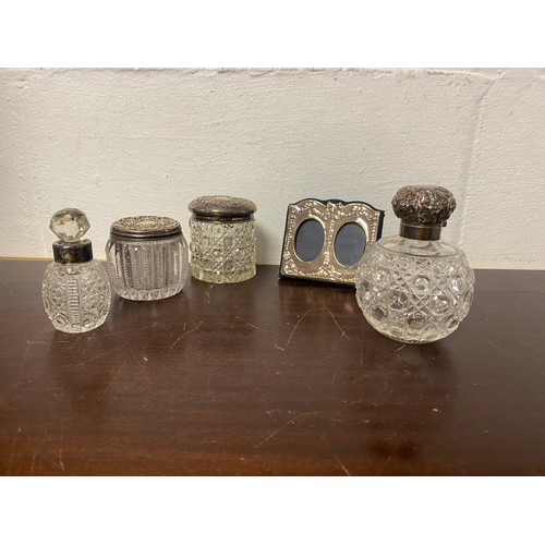 12 - A late Victorian silver mounted scent bottle, Birmingham 1900, two silver lidded jars, a bottle with... 