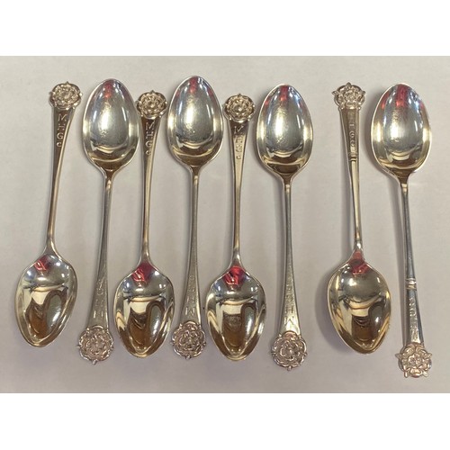 27 - A set of six George VI teaspoons, Sheffield 1949, and a similar pair, all with rose terminal -