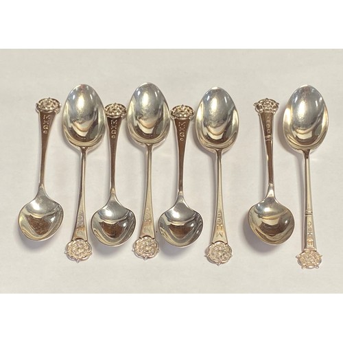 27 - A set of six George VI teaspoons, Sheffield 1949, and a similar pair, all with rose terminal -