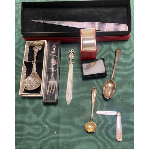 52 - A small quantity of silver and white metal items, to include napkin ring, letter opener, odd spoons ... 