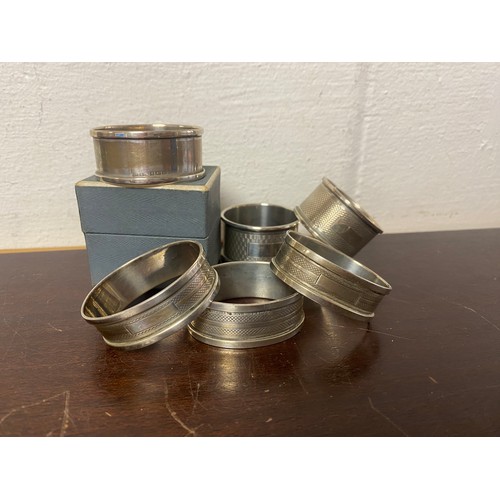 57 - A group of six hallmarked silver napkin rings, various dates and makers -