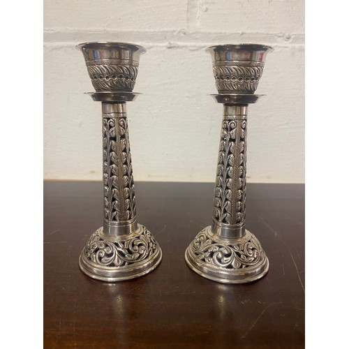 67 - A pair of candlesticks, each with pierced stem and base -