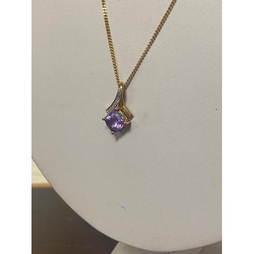 68 - An amethyst and diamond pendant, on long 9ct chain -