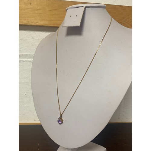 68 - An amethyst and diamond pendant, on long 9ct chain -