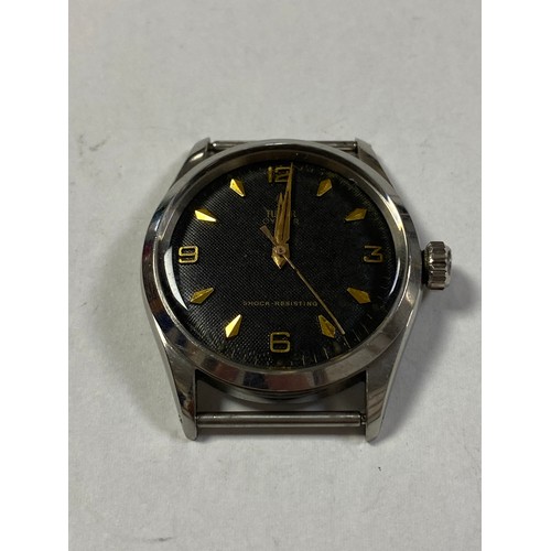 73 - A Rolex Tudor Oyster watch head, with black dial, gilt hands, makers and Arabic numbers -