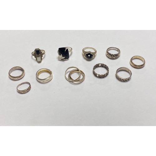 112 - A group of eleven silver rings, some stone set and some knotwork bands -