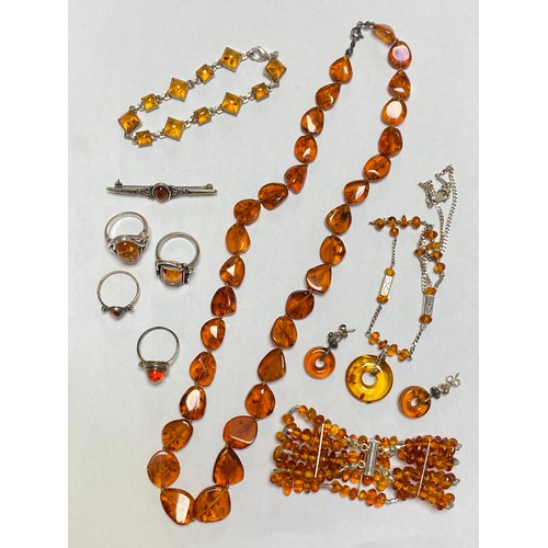 114 - A group of mostly silver and amber jewellery, to include bracelet, three rings, beads etc -