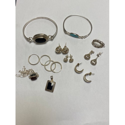 120 - A quantity of silver jewellery, to include two bangles, fob pendant on chain, earrings etc -