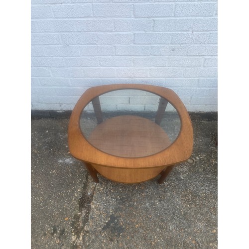 357 - A retro teak and glass coffee table, with circular glass inset over shaped top, over undertier -