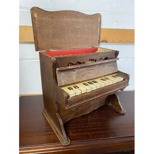 235 - A novelty German toy piano, the wooden case painted with flower decoration -