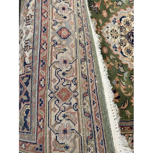 367 - An Eastern green ground rug -