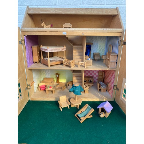 264 - A modern dolls house and a quantity of furnishings -