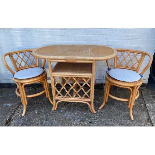 377 - A cane/bamboo breakfast table and two chairs -